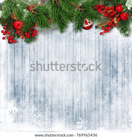 Christmas border with firtree,holly and Christmas wreath on wooden snowy board