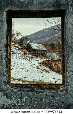 A winter view through a wood rustic window