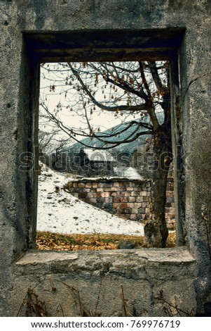 A winter view through a wood rustic window