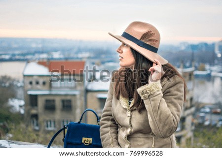 Fashionable girl walking in the park on a winter day