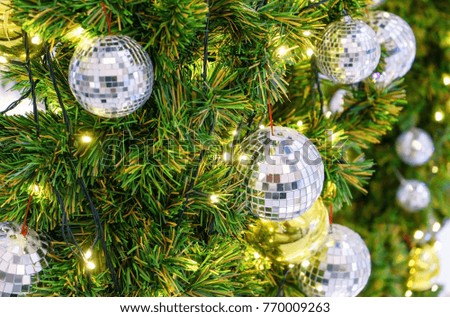 Christmas decoration with many glitter bauble balls, shinny baubles and pine cones on the artificial pine tree
