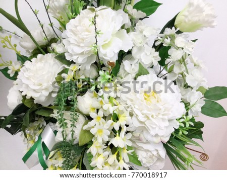 Decorative artificial white flowers in vase 