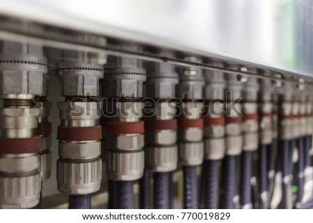 Electrical wires or cables are connected to junction box by using the metal electrical cable gland for connecting to the junction box cabinet. Royalty-Free Stock Photo #770019829