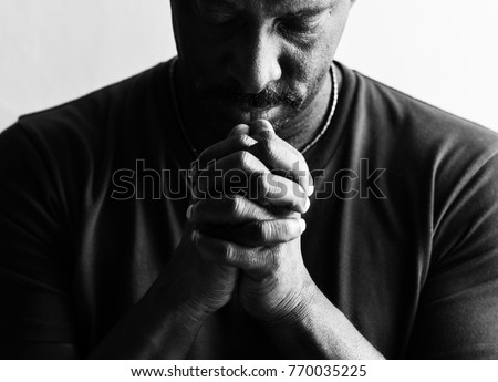 African American man resting his chin on his hands  Royalty-Free Stock Photo #770035225
