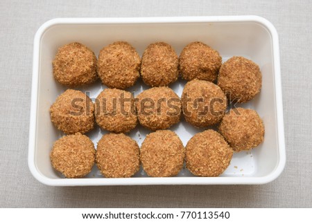 Top view of sweet rice cashew or peanut balls, popular traditional tea time snack of Kerala India made of flour, coconut, and jaggery on Onam, Vishu, Ramadan festivals. South Indian food. Mithai