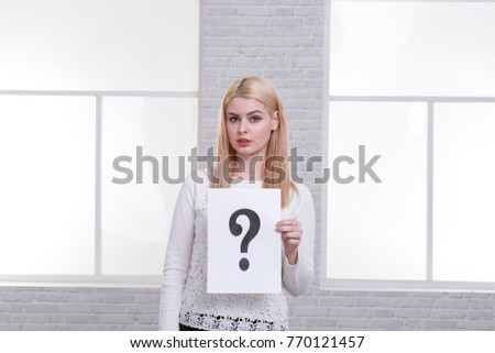 Girl holding a leaf with a question mark