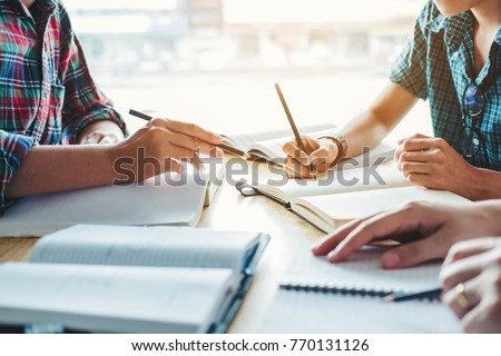 High school or college students studying and reading together in library education concepts Royalty-Free Stock Photo #770131126