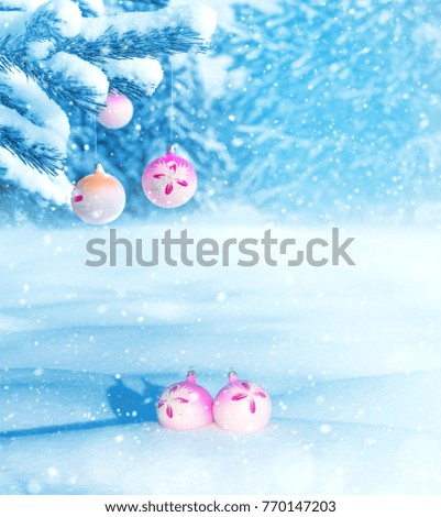 Winter landscape. Christmas balls on coniferous branch in  snow-covered forest. Winter background.