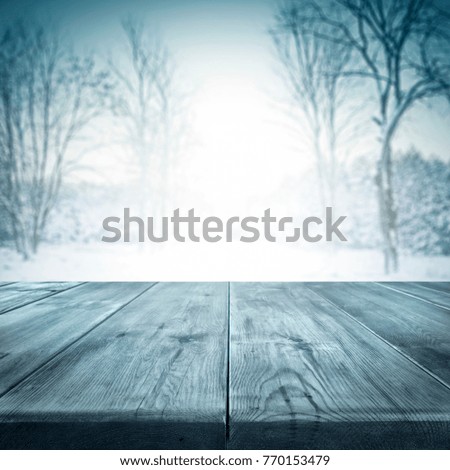 Wooden desk space and winter time background 