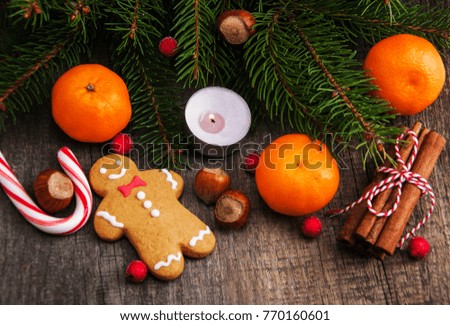 Christmas gingerbread cookie and tangerines on a wooden background