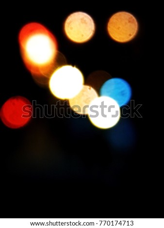 Blurred Abstract Colorful Bokeh Background, white, orange, blue, red, yellow in black Background, have Copy Space at lower of Picture, Minimal Concept 