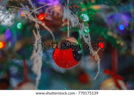 Christmas tree with baubles and bullfinch decorations. 