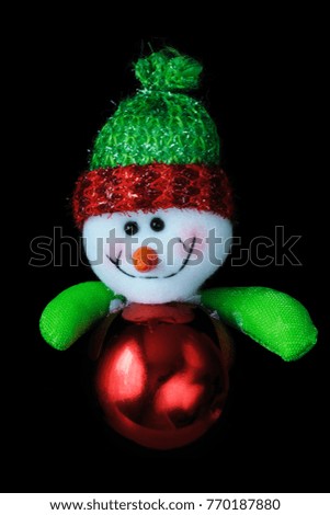 toy snowman decoration on a black background