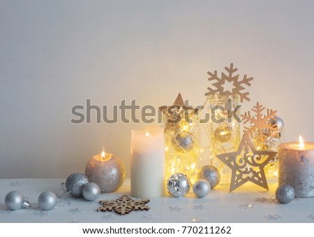 Christmas decoration with candles on background  white wall