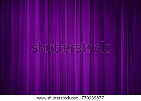 Purple fabric background. Draped curtain hanging close-up. Decorative Wallpaper or Web Banner With Copy Space for design.