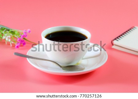 Flat lay photo with Coffee cup, Notebook and flower on Pink Pastel color background