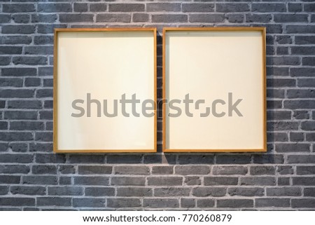 wooden  frames with free space for advertising or picture posting hanged on retro style gray brick wall. 