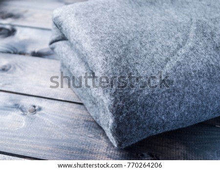 Grey blanket on a wooden background