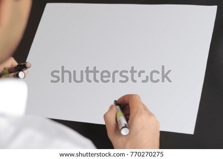 The hand of the designer with a marker on white background mock up