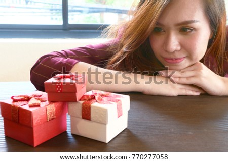 Women feel happy and looking gifts on the table.