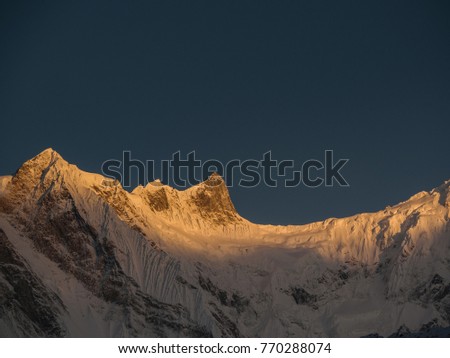 The first rays of the sun on the Annapurna saddle, Nepal, Asia