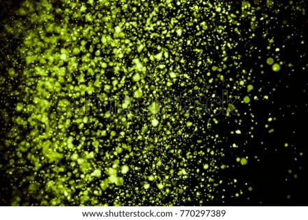 abstract green powder explosion on black background   