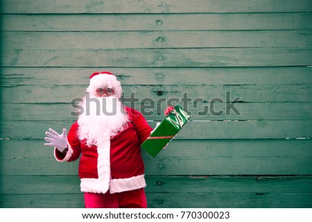Santa claus with gift box on wood background,Thailand people,Sent happiness for children,Merry christmas,Welcome to winter