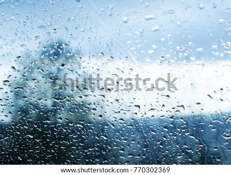 Drops of rain on glass. Raindrops on automotive glass