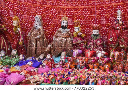 Hand made puppets attached to string in Rajasthan India. Dolls men and women face wearing traditional Indian dress Saree or Sari, Lehenga for plays, dance at Dilli Haat for Dussehra, Diwali festival