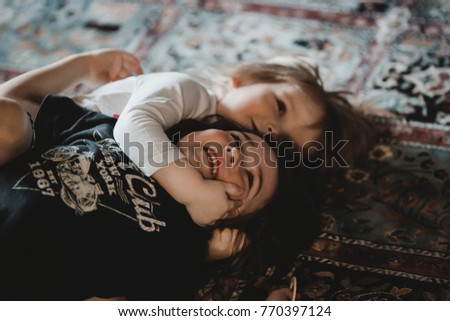 Little children hug and play on the carpet