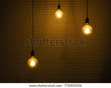 hanging round light bulb with brick wall back ground