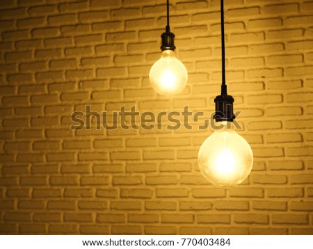 hanging round light bulb with brick wall back ground