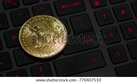 golden bitcoin on keyboard