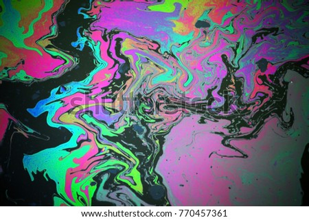 Abstract colorful rainbow oil slick on water background Royalty-Free Stock Photo #770457361