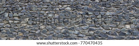 Panoramic texture of gray stonewall Royalty-Free Stock Photo #770470435