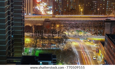 A view of the local Manhattan streets and Brooklyn Bridge at night with a slow shutter speed. 