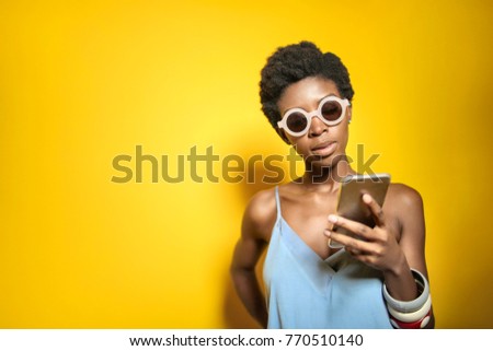 Fashionable girl checking her phone