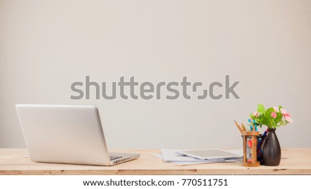 Comfortable working place. Close-up of comfortable working place in office with wooden table and laptop laying on it