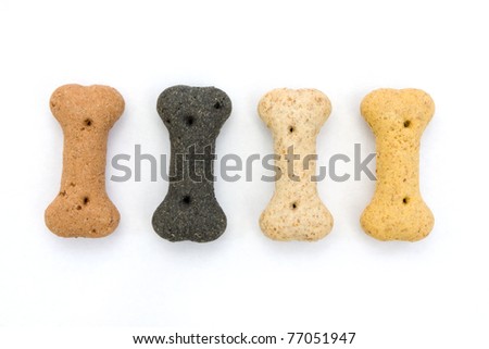 Line of bone shaped dog biscuits over white Royalty-Free Stock Photo #77051947