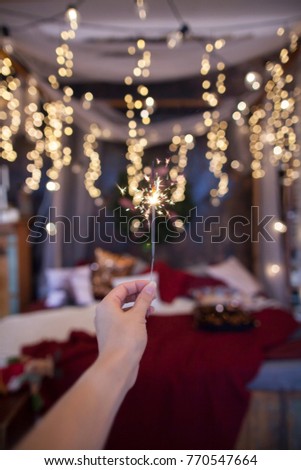 Night background with a star christmas sparkler. Sparkler Bokeh Colorful sparkler. Shallow focus