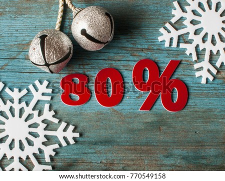 Christmas decoration with snowflakes and symbol of percent on wooden background