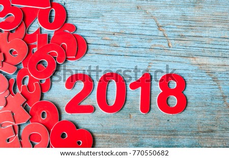 numbers forming the number 2018, for the new year 2018 on rustic wooden background with christmas decoration.