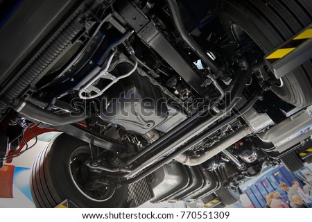 View on commercial truck chassis under cabin different pneumatic, electric equipment and various parts details. Truck workshop. Car under inspection maintenance repair on lift. Truck MOT tools Royalty-Free Stock Photo #770551309