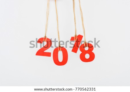 close up view of 2018 year sign hanging on strings isolated on white
