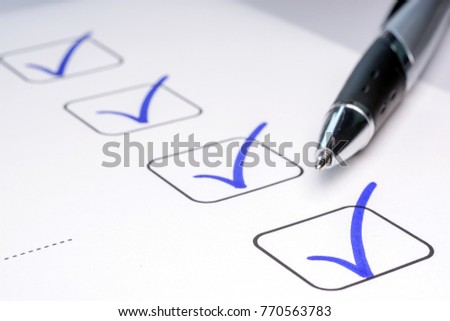 Check off completed tasks on a to-do list Royalty-Free Stock Photo #770563783