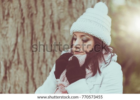 Portrait of young pretty woman wearing warm clothes outdoors