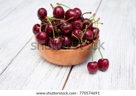 Ripe juicy cherries on a wooden background