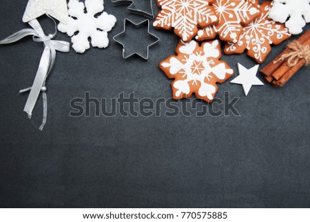 Christmas ginger cookies on a black stone background