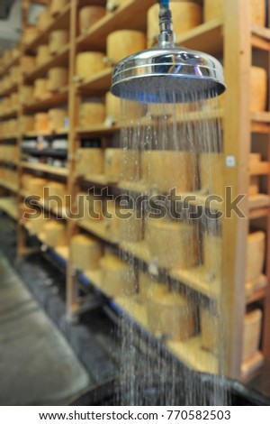Shower over the barrel for humidify the air in the traditional hard cheeses shop on the Borough Market in London