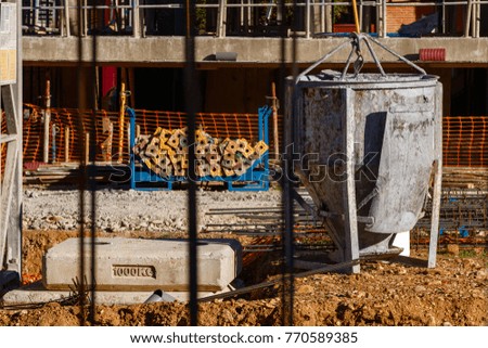 Constructing a building. Cement container. Construction material and start of the structure of a set of houses.